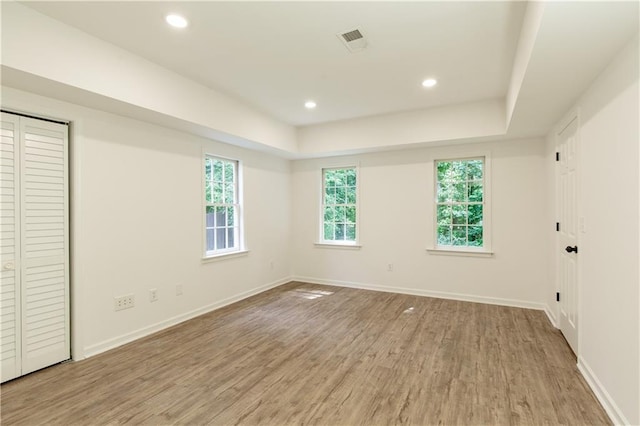 3795 Newport Bay Dr, Alpharetta, GA 30005 - unfurnished bedroom with light wood-style floors, a tray ceiling, and recessed lighting