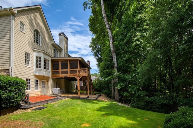 3795 Newport Bay Dr, Alpharetta, GA 30005 - back of property with a sunroom, a chimney, a lawn, and a wooden deck