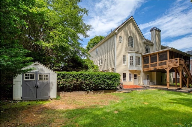 3795 Newport Bay Dr, Alpharetta, GA 30005 - rear view of house with a sunroom, a chimney, a storage shed, stairway, and a lawn