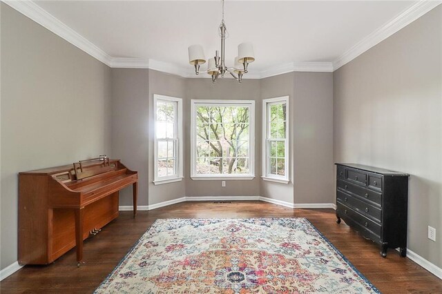 misc room featuring dark hardwood / wood-style floors, ornamental molding, and an inviting chandelier