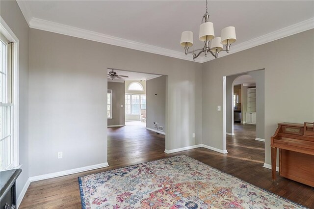 dining area featuring ornamental molding, ceiling fan with notable chandelier, and dark hardwood / wood-style flooring