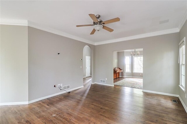 spare room with ornamental molding, ceiling fan with notable chandelier, and dark hardwood / wood-style flooring