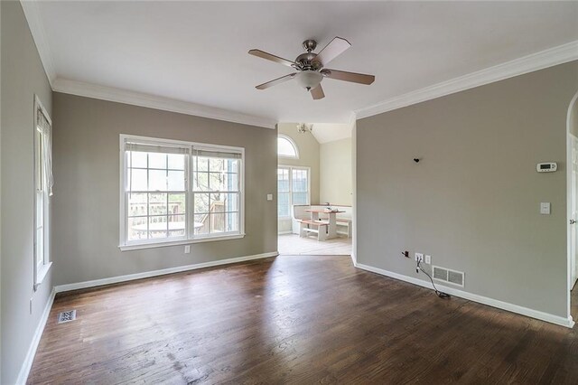 unfurnished room featuring ceiling fan, ornamental molding, lofted ceiling, and dark hardwood / wood-style floors