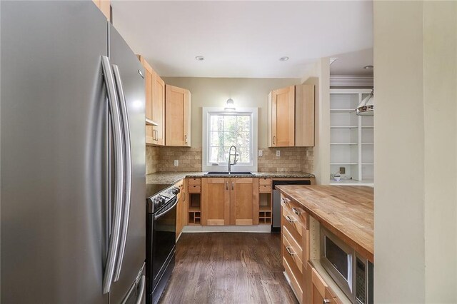 kitchen with backsplash, wooden counters, sink, dark wood-type flooring, and appliances with stainless steel finishes