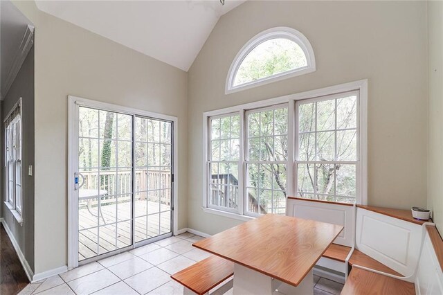 tiled dining area with lofted ceiling