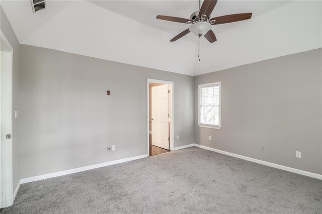 carpeted empty room with ceiling fan and vaulted ceiling