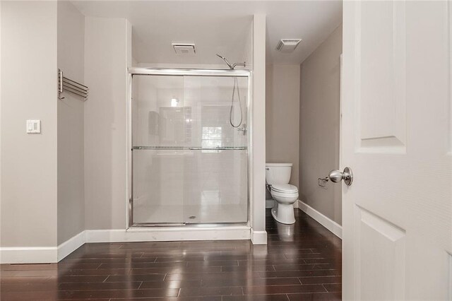 bathroom featuring toilet and walk in shower