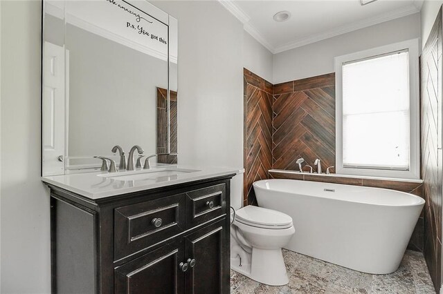 bathroom with crown molding, toilet, vanity, and a bathing tub