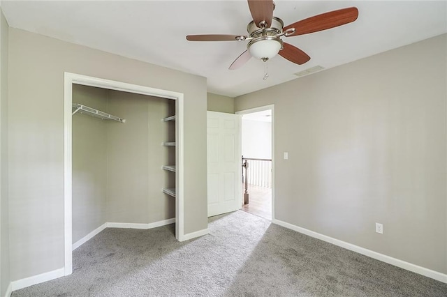 unfurnished bedroom featuring ceiling fan, a closet, and light colored carpet