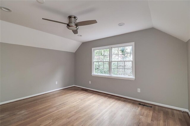 bonus room featuring light hardwood / wood-style floors, ceiling fan, and vaulted ceiling