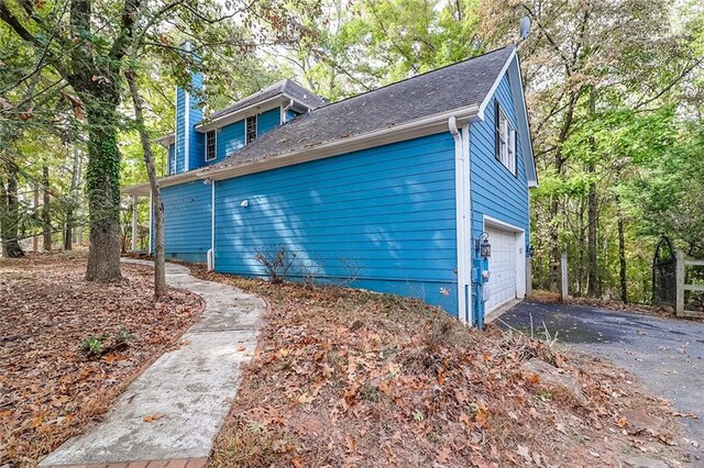 view of side of home featuring a garage