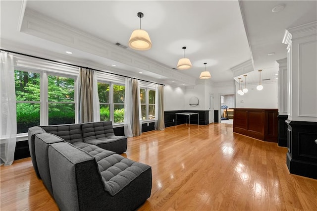 living room featuring light hardwood / wood-style floors and crown molding