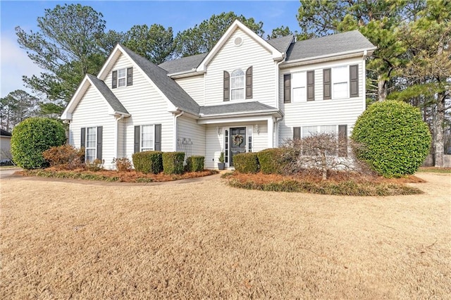 front facade with a front yard