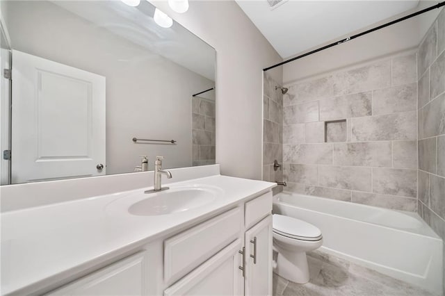 full bathroom with toilet, vanity, and tiled shower / bath