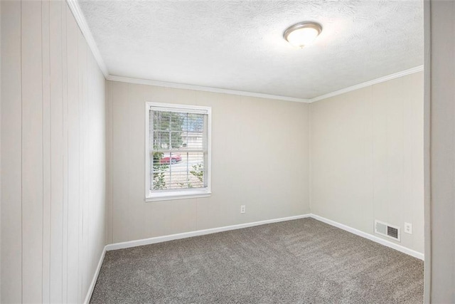 empty room with baseboards, visible vents, ornamental molding, a textured ceiling, and carpet flooring