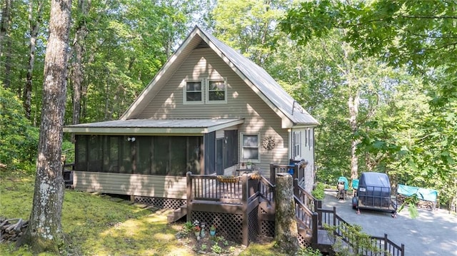 50 Shawnee Trl, Chatsworth, GA 30705 - view of front of property with a sunroom and a wooden deck