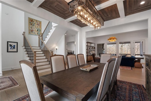 120 Nezhat Pl, Atlanta, GA 30350 - dining area with wood finished floors, a chandelier, stairs, and baseboards