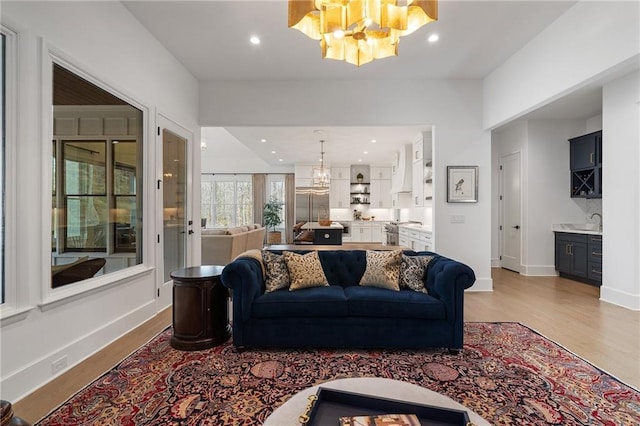 120 Nezhat Pl, Atlanta, GA 30350 - living area featuring a chandelier, light wood-style flooring, recessed lighting, and baseboards