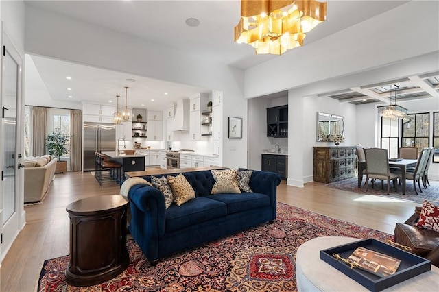 120 Nezhat Pl, Atlanta, GA 30350 - living area featuring a chandelier, light wood-style floors, plenty of natural light, coffered ceiling, and beam ceiling