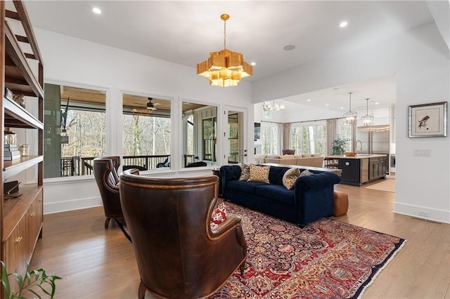 120 Nezhat Pl, Atlanta, GA 30350 - living room with a chandelier, wood finished floors, baseboards, recessed lighting, and ceiling fan