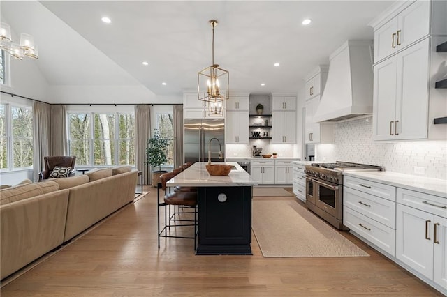 120 Nezhat Pl, Atlanta, GA 30350 - kitchen with premium appliances, open shelves, custom range hood, open floor plan, and a chandelier