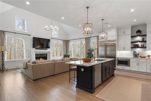 120 Nezhat Pl, Atlanta, GA 30350 - kitchen with a sink, a chandelier, stainless steel microwave, light wood-style floors, and recessed lighting