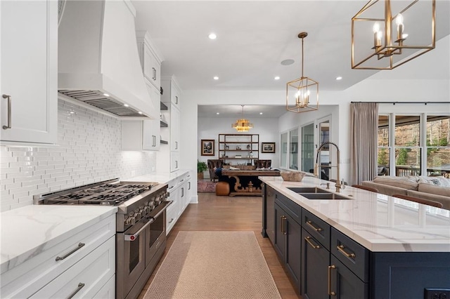 120 Nezhat Pl, Atlanta, GA 30350 - kitchen with open floor plan, double oven range, a sink, custom range hood, and a chandelier