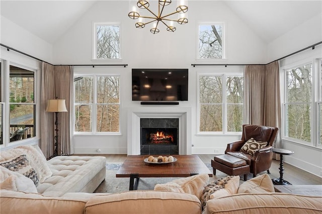 120 Nezhat Pl, Atlanta, GA 30350 - living room with high vaulted ceiling, wood finished floors, a fireplace, a chandelier, and baseboards