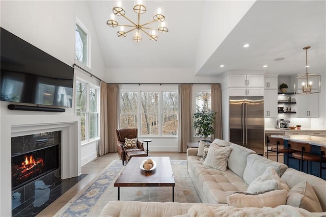 120 Nezhat Pl, Atlanta, GA 30350 - living area featuring a chandelier, recessed lighting, high vaulted ceiling, and a premium fireplace