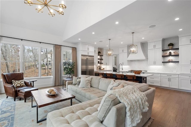 120 Nezhat Pl, Atlanta, GA 30350 - living area featuring a chandelier, recessed lighting, light wood-type flooring, and a high ceiling
