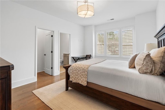 120 Nezhat Pl, Atlanta, GA 30350 - bedroom featuring wood finished floors, baseboards, and ensuite bathroom