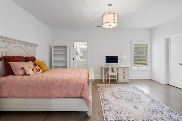 120 Nezhat Pl, Atlanta, GA 30350 - bedroom with wood finished floors, baseboards, and connected bathroom
