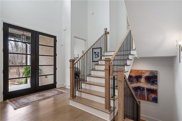 120 Nezhat Pl, Atlanta, GA 30350 - entrance foyer with french doors, healthy amount of natural light, wood finished floors, a high ceiling, and baseboards
