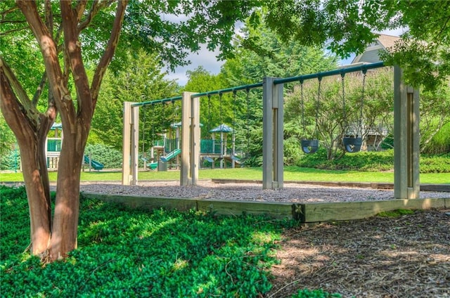 community jungle gym featuring a lawn