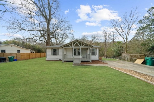 rear view of property with a porch and a lawn