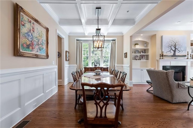 2283 Falmouth Ct SE Unit 22, Smyrna, GA 30080 - dining space featuring a chandelier, built in shelves, dark wood finished floors, beam ceiling, and ornamental molding