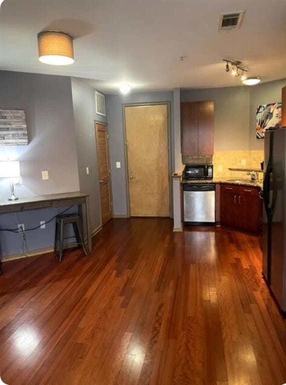 kitchen with stainless steel appliances, sink, backsplash, and dark hardwood / wood-style flooring