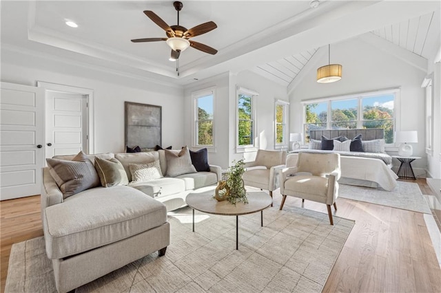 living room with lofted ceiling with beams, ceiling fan, and light hardwood / wood-style flooring