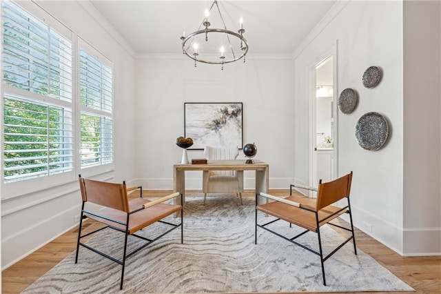 sitting room featuring a chandelier, ornamental molding, and light hardwood / wood-style flooring