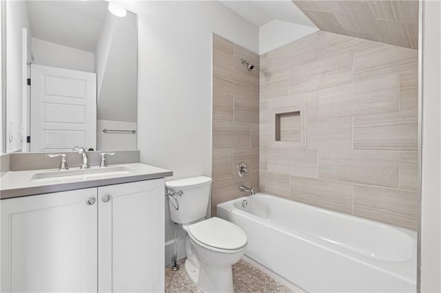 full bathroom with vanity, lofted ceiling, tile patterned flooring, tiled shower / bath combo, and toilet