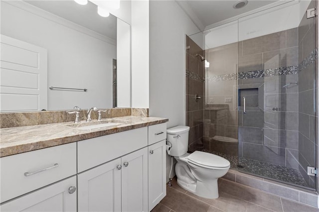 bathroom featuring tile patterned floors, walk in shower, vanity, crown molding, and toilet