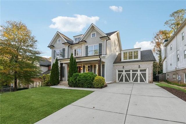 craftsman-style home featuring covered porch, a garage, and a front lawn