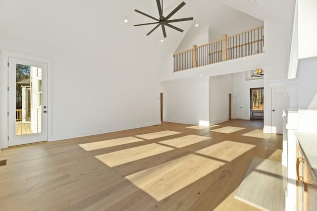 2410 Glade Overlook, Cumming, GA 30041 - unfurnished living room featuring high vaulted ceiling, light wood-style floors, ceiling fan, plenty of natural light, and recessed lighting