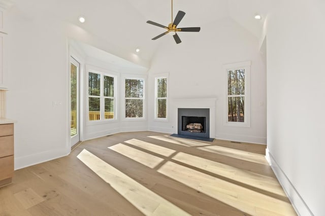 2410 Glade Overlook, Cumming, GA 30041 - unfurnished living room featuring plenty of natural light, a fireplace with flush hearth, recessed lighting, light wood-style floors, and a ceiling fan