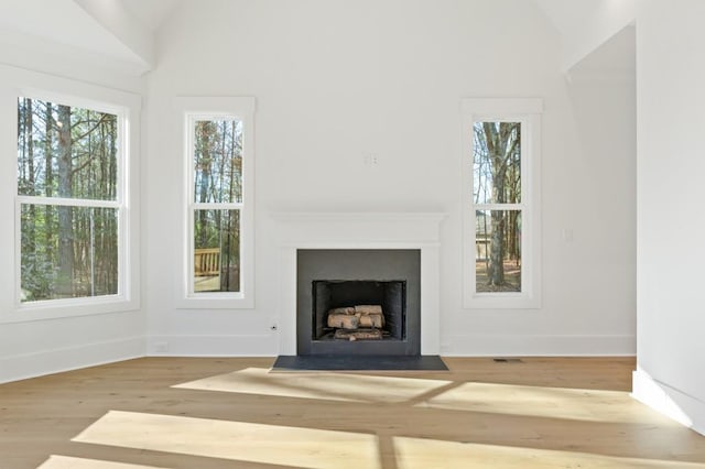 2410 Glade Overlook, Cumming, GA 30041 - unfurnished living room featuring lofted ceiling, a fireplace with flush hearth, and wood finished floors