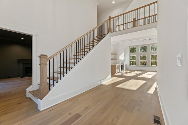 2410 Glade Overlook, Cumming, GA 30041 - stairway with a high ceiling, wood finished floors, a fireplace, and recessed lighting
