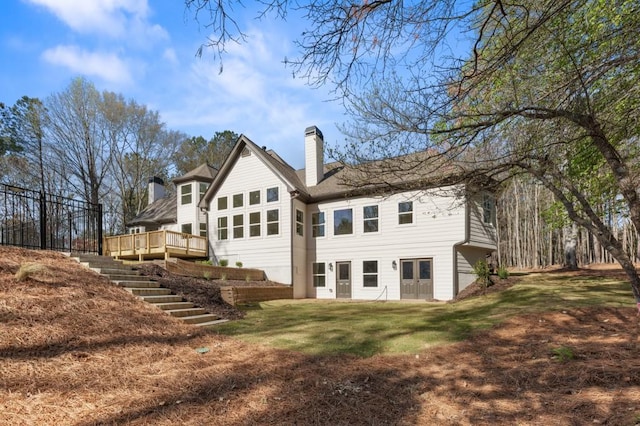 2410 Glade Overlook, Cumming, GA 30041 - rear view of house with a chimney, stairway, a deck, and a lawn