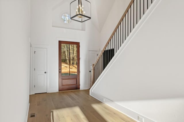 2410 Glade Overlook, Cumming, GA 30041 - foyer entrance featuring stairway, high vaulted ceiling, wood finished floors, and a chandelier
