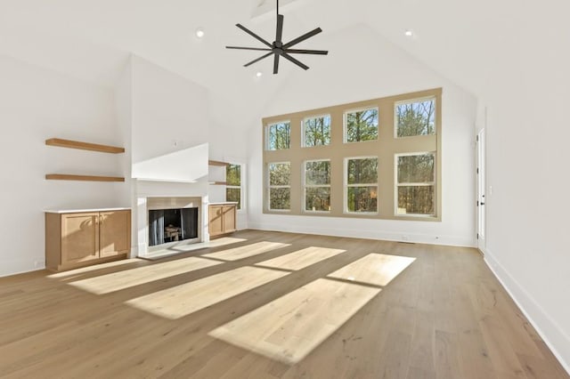 2410 Glade Overlook, Cumming, GA 30041 - unfurnished living room featuring high vaulted ceiling, ceiling fan, light wood-style floors, a fireplace with flush hearth, and recessed lighting