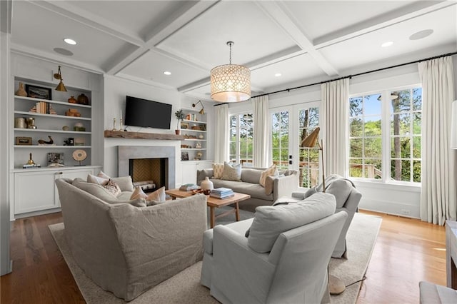 1141 Ragley Hall Rd NE, Brookhaven, GA 30319 - living area featuring wood finished floors, coffered ceiling, and a healthy amount of sunlight